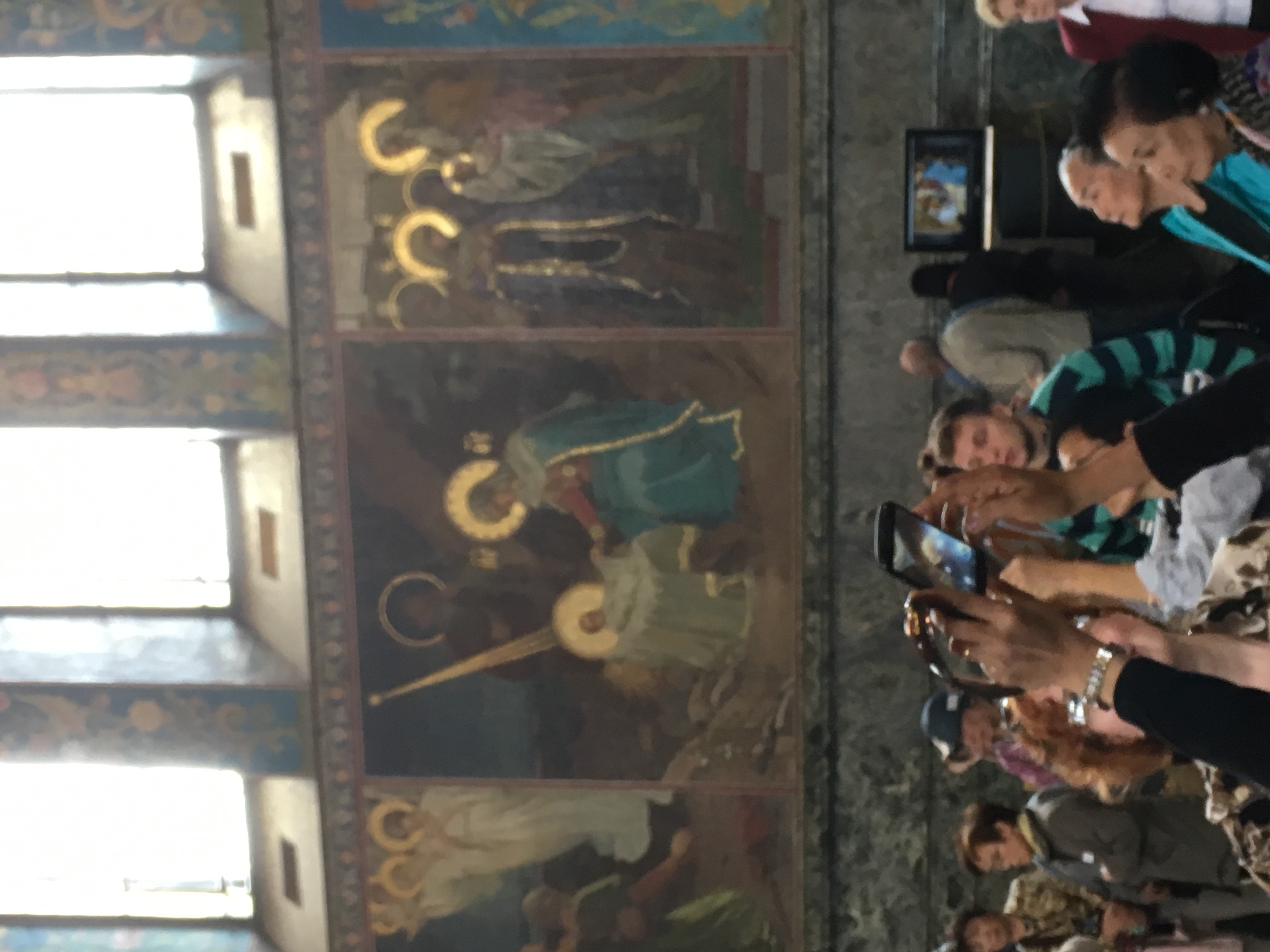 People taking photos inside a decorated church