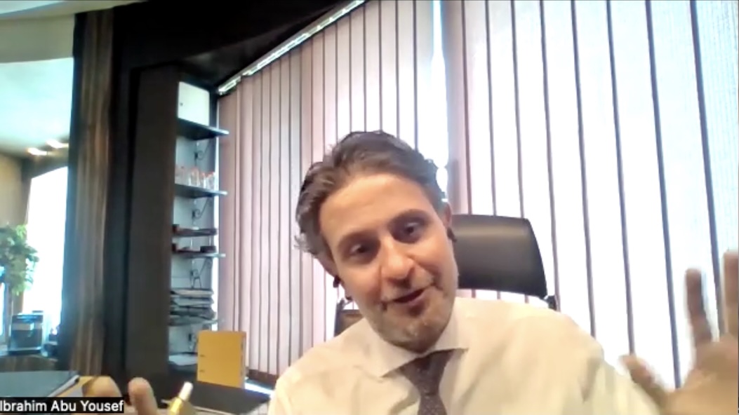 Ibrahim Abu Yousef, mid-conversation on a Zoom call, explaining something with evident confidence Ibrahim Abu Yousef, mid-conversation on a Zoom call, explaining something with evident confidence