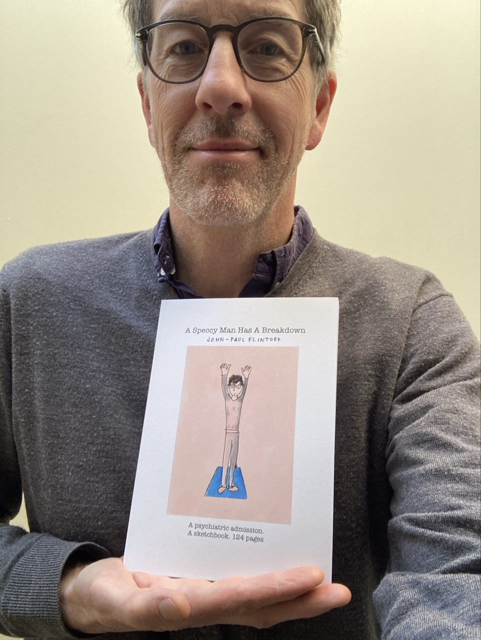 John-Paul Flintoff holding a copy of his new book, A Speccy Man Has A Breakdown.