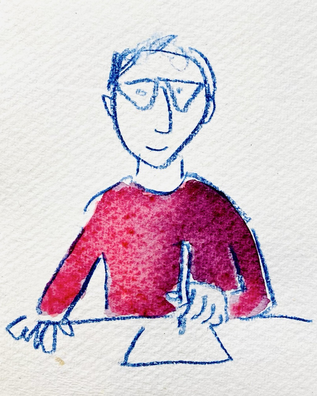 Speccy Man drawing at a table, in splendid vibrant dark red top, looking to camera with a smile. Speccy Man drawing at a table, in splendid vibrant dark red top, looking to camera with a smile.