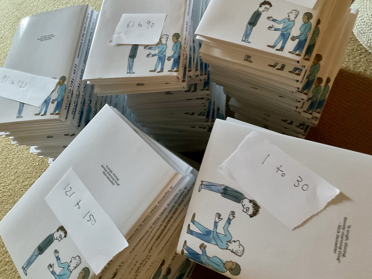 Piles of numbered books with handwritten note on each pile.