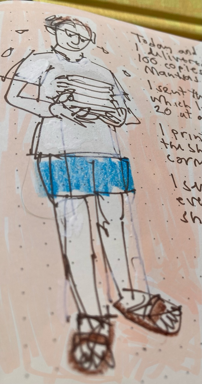 Smiling Speccy JPF carrying a pile of books, wearing shorts and Birkenstock sandals. Smiling Speccy JPF carrying a pile of books, wearing shorts and Birkenstock sandals.