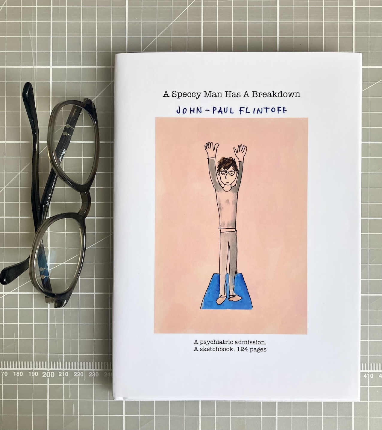 A Speccy Man Has a Breakdown - hardback book with a pair of glasses laid alongside.