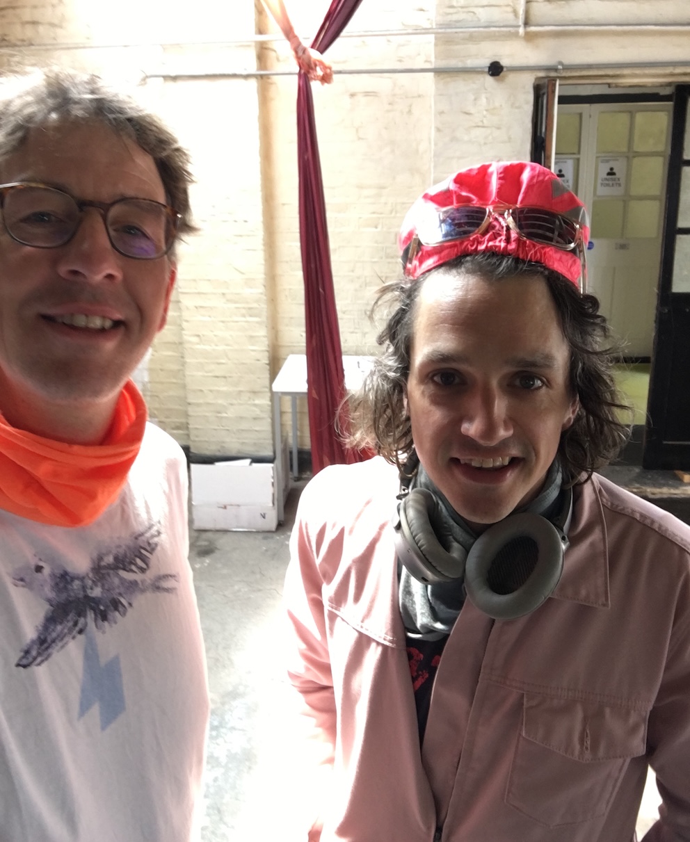 Photo of JPF on the left and Joel, right, dressed in a boiler suit with ear protectors around his neck. Photo of JPF on the left and Joel, right, dressed in a boiler suit with ear protectors around his neck.