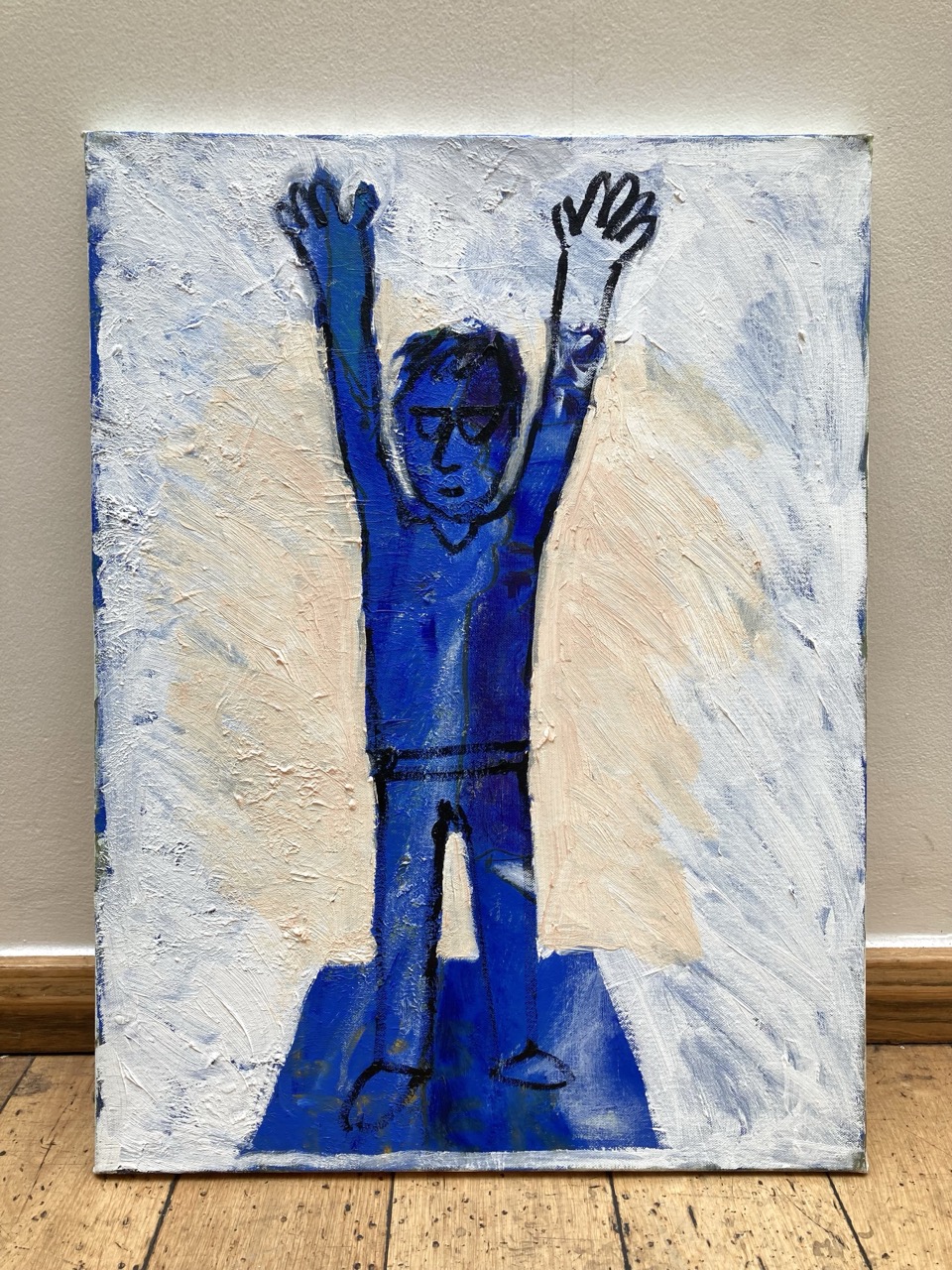 Unframed oil painting. Blue figure with raised arms on a rectangular mat, white background, some pink around the figure.