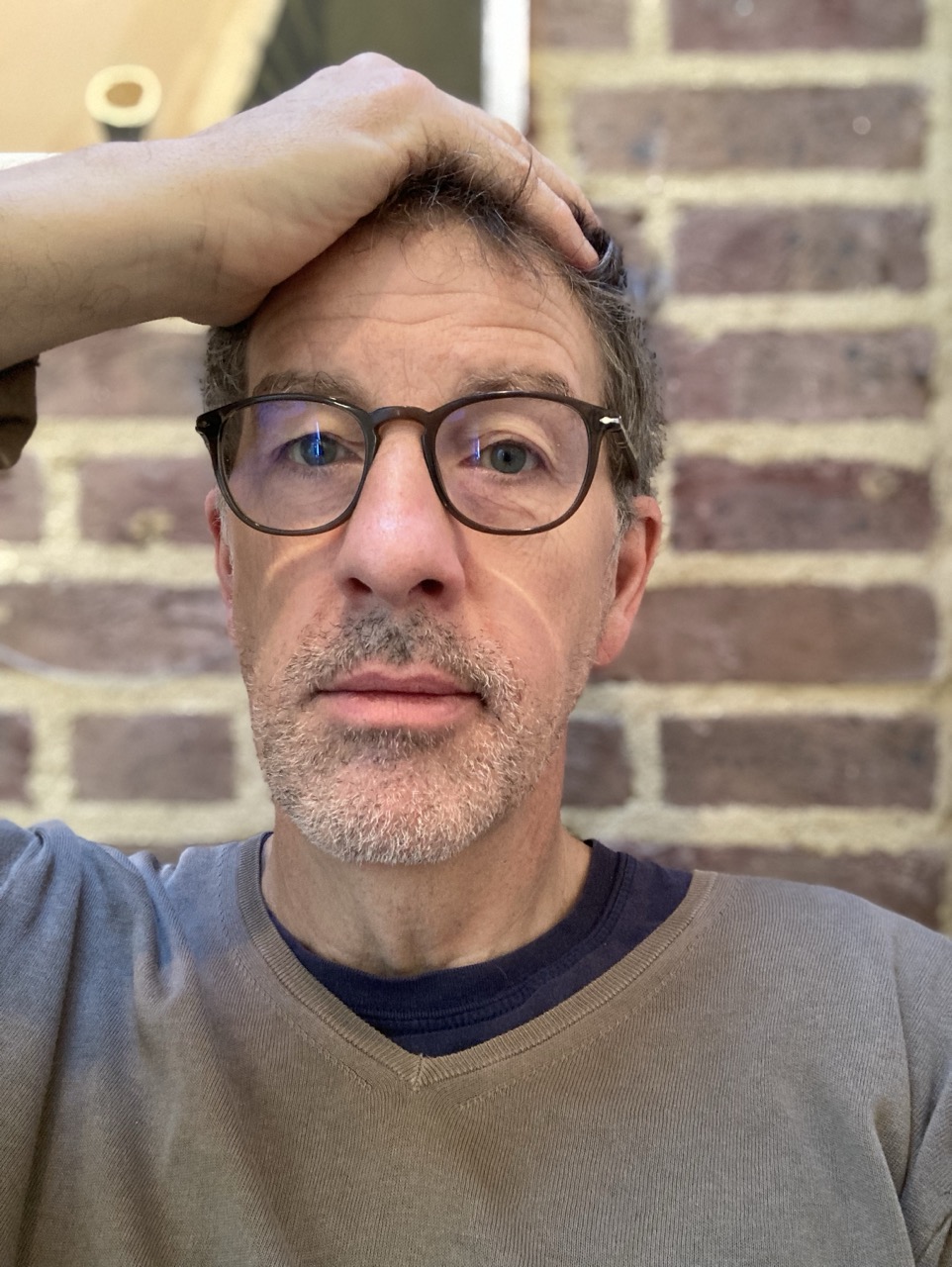 Photo of JPF with hand on head.