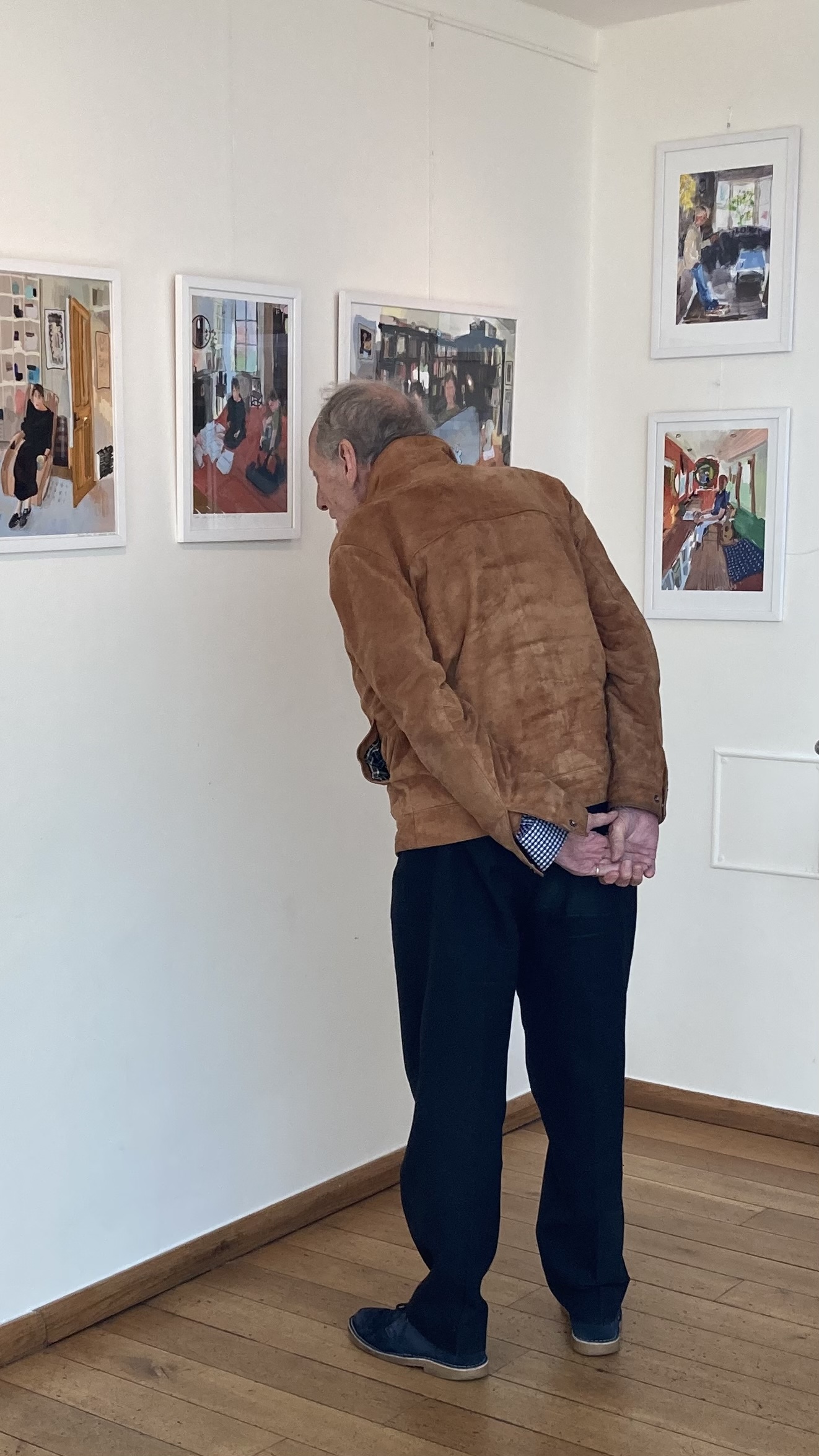 My father, seen from behind, leans in closely to examine framed prints in a corner of the Burgh House gallery.