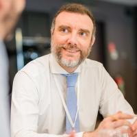 Alberto at a TGS conference table, smiling Alberto at a TGS conference table, smiling